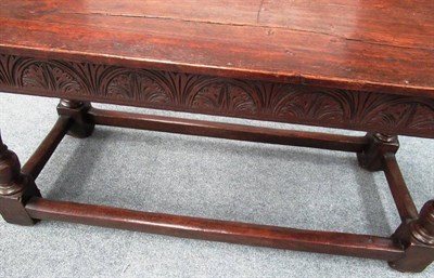 Lot 679 - A Carved Oak Refectory Table, the later top above a lunette carved frieze, on turned legs with...