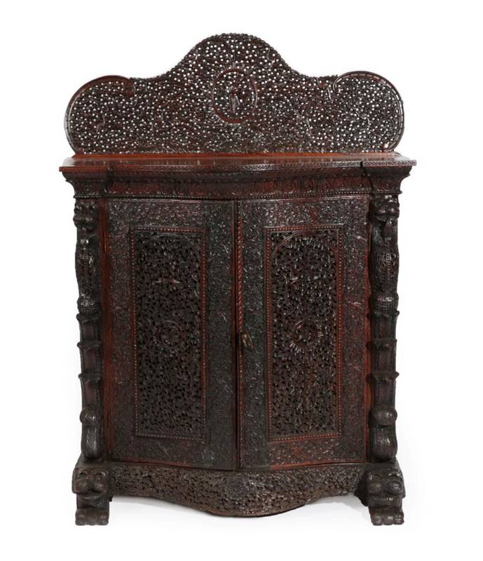 Lot 735 - A Mid 19th Century Carved Rosewood Serpentine Shaped Cabinet, probably Bombay, circa 1850,...