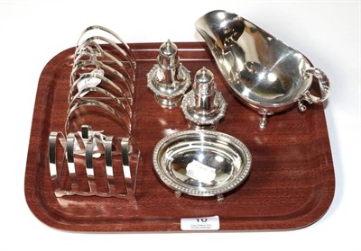 Lot 10 - A silver sauce boat, Thomas Levesley, Sheffield 1919; two toast racks, Birmingham 1929 and...