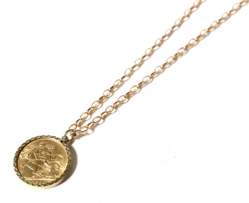 Lot 52 - A full gold sovereign dated 1910 set in a 9 carat gold framed mount, on chain with clasp...