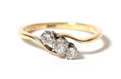 Lot 61 - A three stone diamond crossover ring, stamped '18ct', finger size R1/2