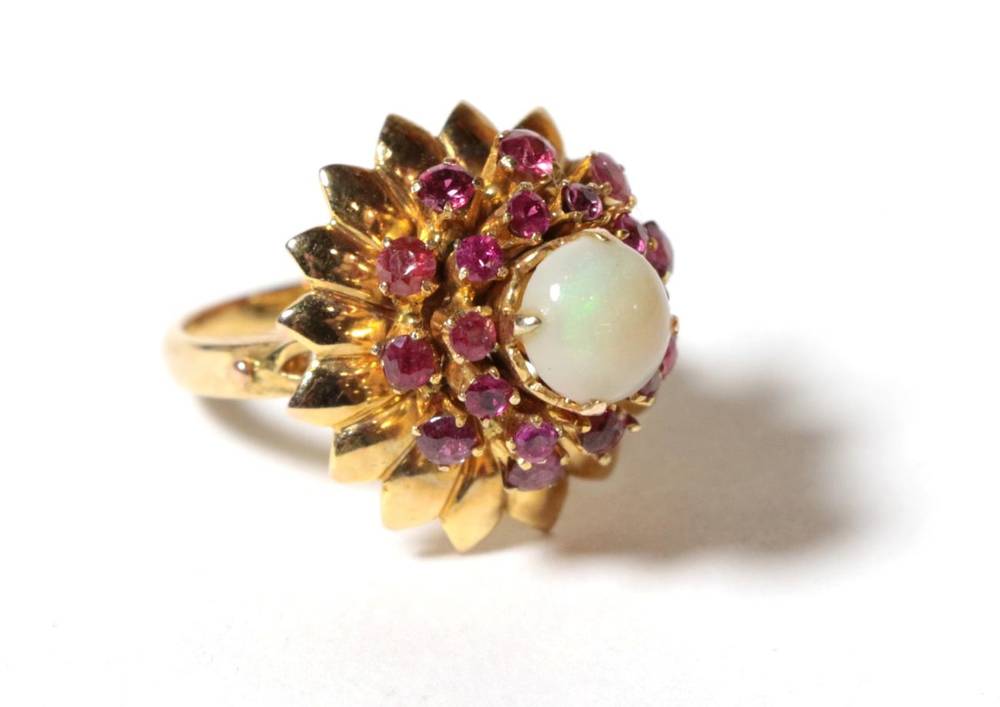 Lot 62 - An opal and ruby cluster ring, a round cabochon opal within a border of round cut rubies and a...
