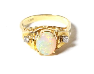 Lot 64 - An opal and diamond three stone ring, an oval cabochon opal spaced by diamonds, finger size J