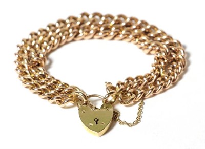 Lot 73 - A double curb link bracelet, each link stamped '9' '375', with heart shaped padlock clasp...
