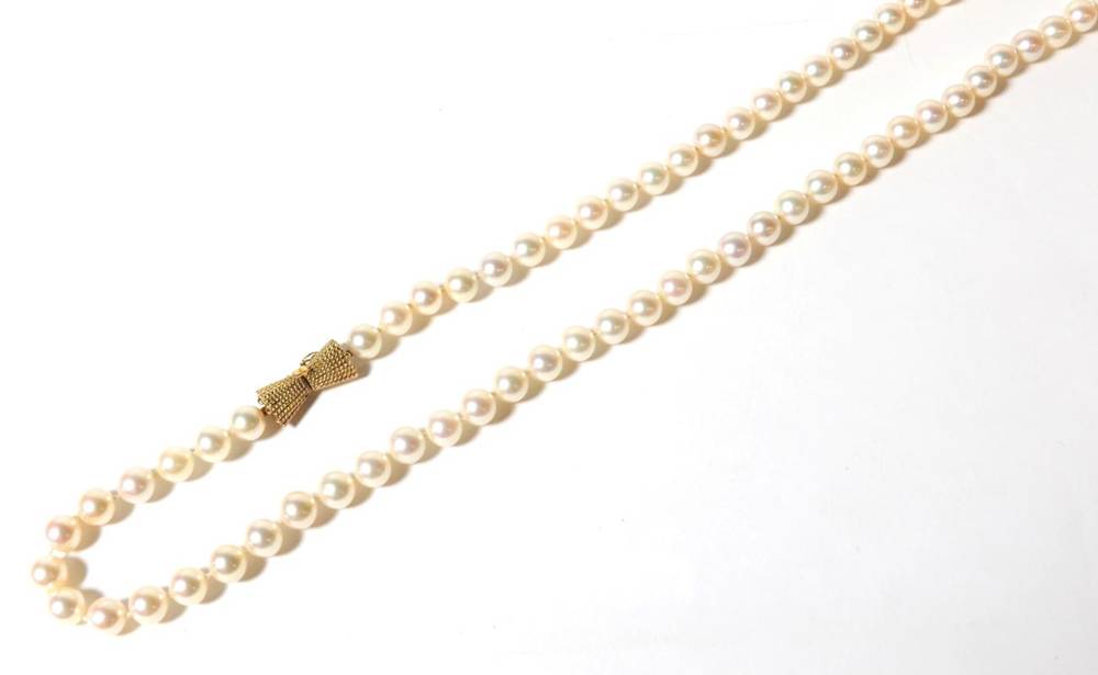 Lot 76 - An Akoya cultured pearl necklace with a bow shaped clasp , length 91cm, stamped '14K'