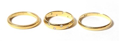 Lot 78 - Two yellow metal band rings, finger sizes M and R; and a diamond set 18 carat gold band ring,...