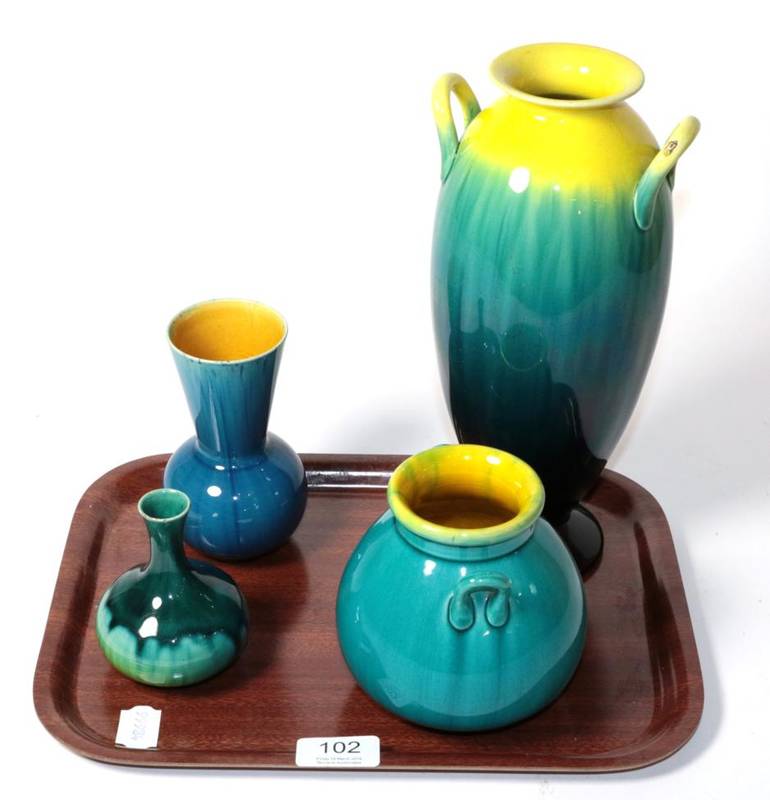 Lot 102 - Four Linthorpe pottery vases including two twin-handled examples, all with a turquoise glaze,...