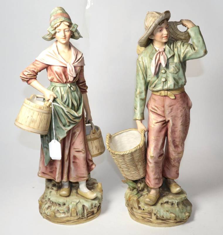 Lot 106 - A pair of large Royal Dux figures of a Dutch fisher boy and girl, carrying baskets and pails,...