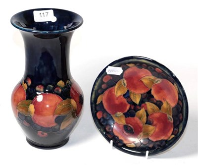Lot 117 - A Moorcroft pottery Pomegranate pattern vase on a blue ground with painted and impressed marks,...