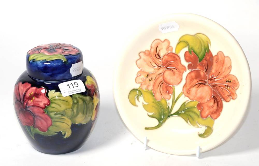 Lot 119 - A Moorcroft pottery Hibiscus pattern ginger jar and cover on a blue ground with painted and...