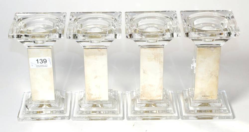 Lot 139 - A set of four silver mounted glass candlesticks, Carr's Ltd, Sheffield 2005, the square column...