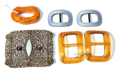 Lot 159 - A pair of silver and enamel belt buckles, a pair of tortoiseshell buckles, an amber type toggle and