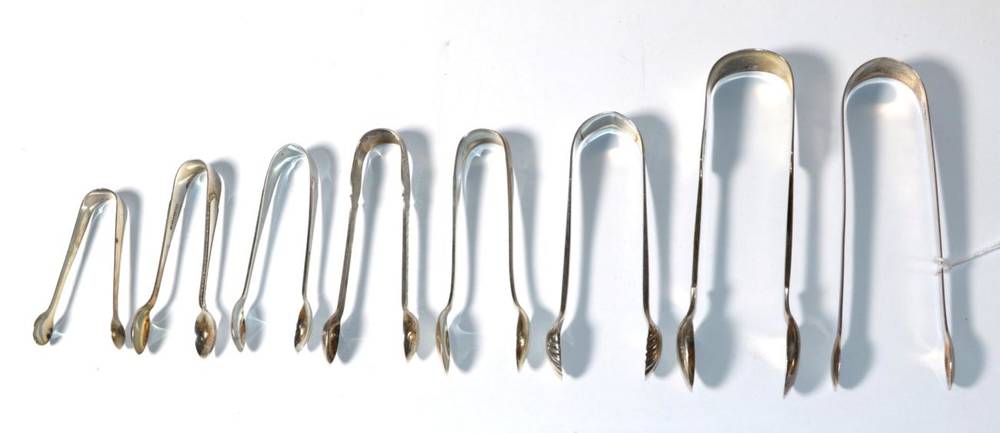 Lot 186 - Eight pairs of George III and later silver sugar tongs, including a pair of fiddle pattern...