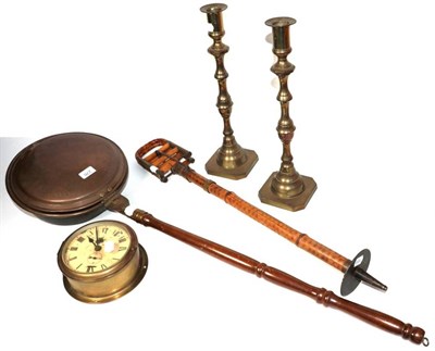 Lot 276 - A brass bulk head clock (with key), a pair of brass candlesticks, a shooting stick and a copper bed