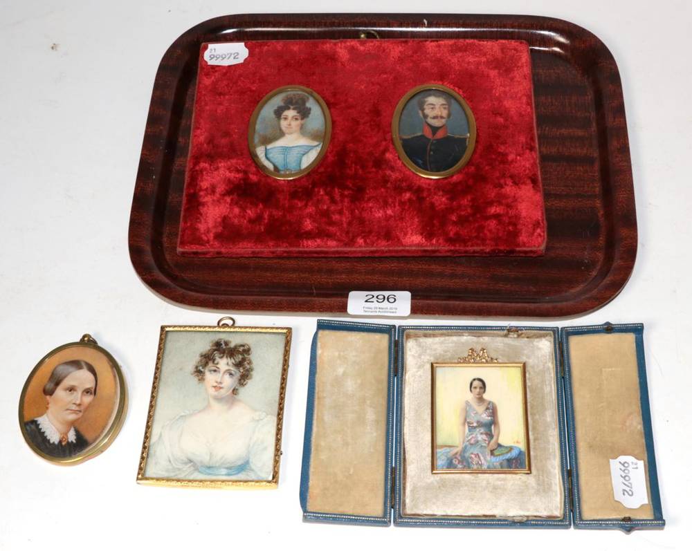 Lot 296 - A pair of 19th century portrait miniatures of a gentleman in military dress; and a lady,...