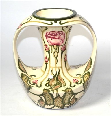 Lot 303 - A Cobridge pottery twin-handled vase decorated by Kerry Goodwin in the Florian rose style...