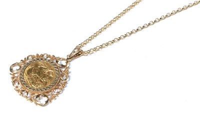 Lot 338 - An 1884 sovereign in a 9 carat gold loose pendant mount, on a chain stamped '375', pendant measures