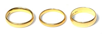 Lot 343 - Three 22 carat gold band rings, of varying widths, finger sizes K1/2, K1/2 and L1/2 (3)