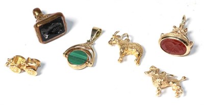 Lot 345 - Three 9 carat gold charms comprising a poodle, a motor car and a goat; a 9 carat gold intaglio seal