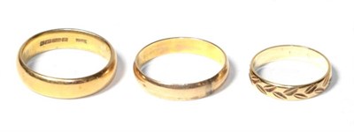 Lot 351 - A 22 carat gold band ring, finger size S1/2; a 9 carat gold band ring, finger size M; and...