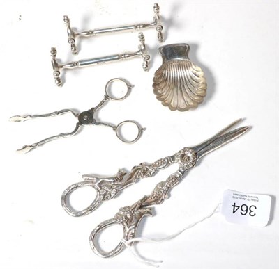 Lot 364 - A pair of silver grape scissors, DJS, London 1967, the handles cast with foxes; a pair of...