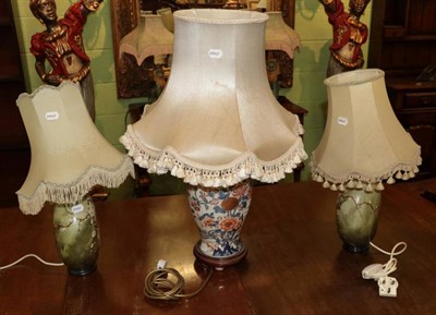 Lot 401 - Oriental style porcelain table lamp, in the Imari palette; and a pair of porcelain table lamps...