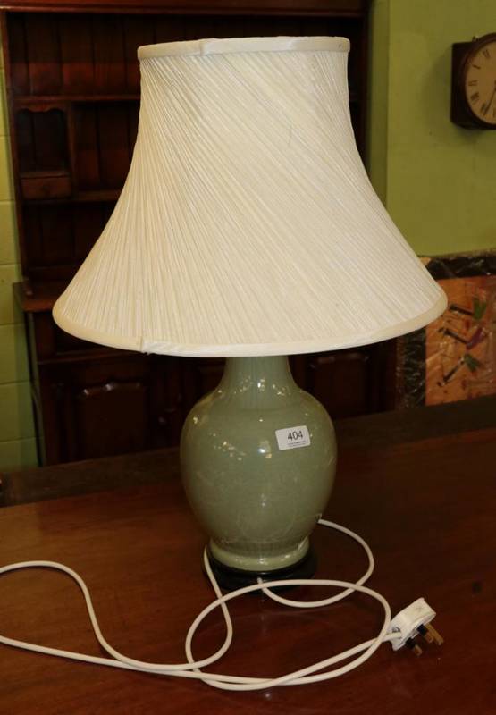 Lot 404 - An Oriental celadon porcelain table lamp with incised decoration