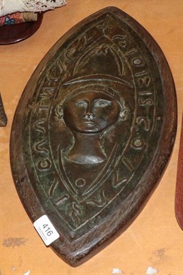 Lot 416 - A copper relief plaque, possibly South American, elliptical shape with central figure, on wood back