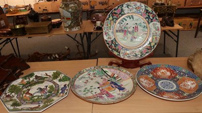 Lot 1098 - Two similar large Oriental porcelain chargers, decorated with figures in garden settings;...