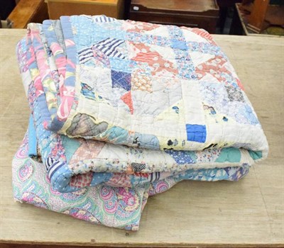 Lot 1112 - Early 20th century reversible paisley style whole cloth single quilt, another with turquoise...