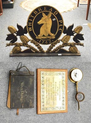 Lot 1148 - A carved wood painted Whitbread sign, a mid century wallpaper sample book, a brass plaque and a...