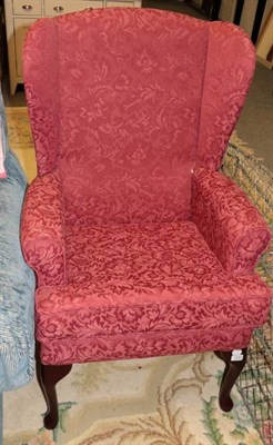 Lot 1183 - A wing-back armchair, modern, labelled HSL The Chair Specialists, upholstered in pink floral...