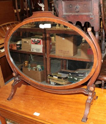 Lot 1200 - A 19th century oval toilet mirror, on swivel mounts