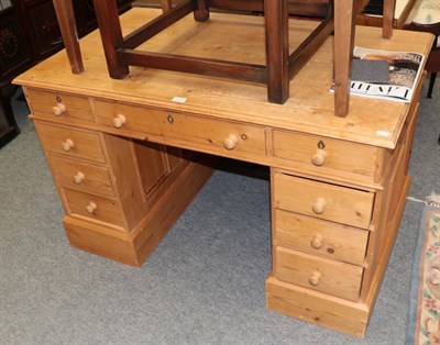 Lot 1210 - A pine double pedestal desk, the moulded top above a central frieze drawer flanked by eight...