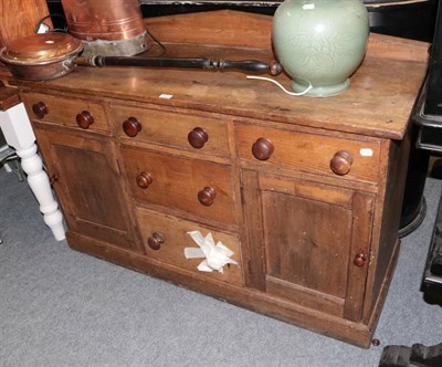 Lot 1223 - A 19th century pine dresser base, with architectural pediment, five drawers and two cupboard doors