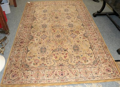 Lot 1253 - Rug of Oriental design, the camel field of flowerheads enclosed by palmette borders, 258cm by 167cm