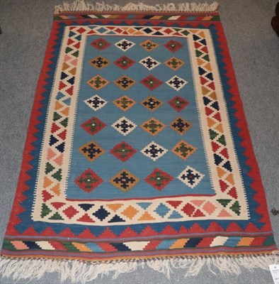 Lot 1259 - Kashgai Kilim, South West Iran, the sky blue field with rows of polychrome stepped guls enclosed by