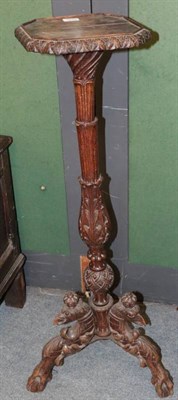 Lot 1274 - A 19th century Continental carved oak torchere, with octagonal shaped platform top, raised on...
