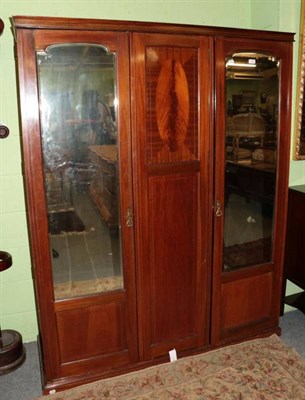 Lot 1278 - A mahogany and barber's pole strung triple door wardrobe, circa 1900, the two arched bevelled glass