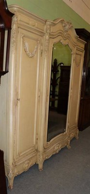 Lot 1282 - A 19th century French cream painted triple door wardrobe, 230cm by 47cm, 243cm high