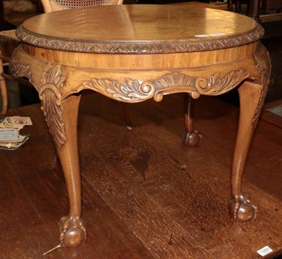 Lot 1290 - A burr walnut circular coffee table, on ball and claw feet
