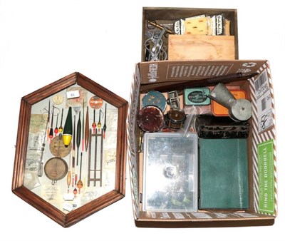 Lot 19 - A box of assorted vintage fishing tackle and accessories, including trout fly reels, bait tins,...