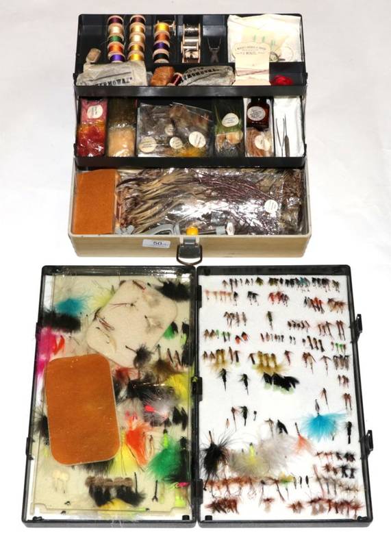 Lot 50 - A plastic cantilevered tackle box containing an assortment of fly tying equipment and...