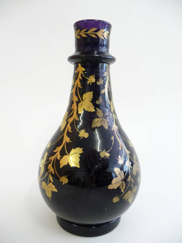 Lot 7 - An Amethyst Glass Pear Shaped Bottle, possibly a Hookah base, circa 1850, gilt with leafy branches