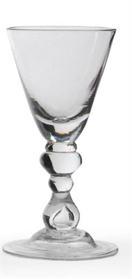 Lot 25 - A Heavy Baluster Wine Glass, circa 1700, the round funnel bowl upon flattened cushion knop and...