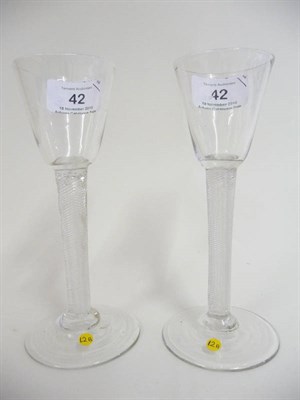 Lot 42 - A Pair of Wine Glasses, circa 1750, each with round funnel bowl upon multiple spiral air twist...