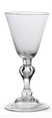 Lot 43 - A Balustroid Wine Glass, circa 1735, the round funnel bowl on a hollow baluster stem, domed and...