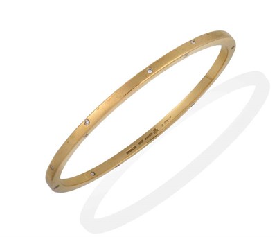 Lot 2009 - An 18 Carat Gold Diamond Constellation Bangle, by Boodles, the plain yellow bangle inset with round