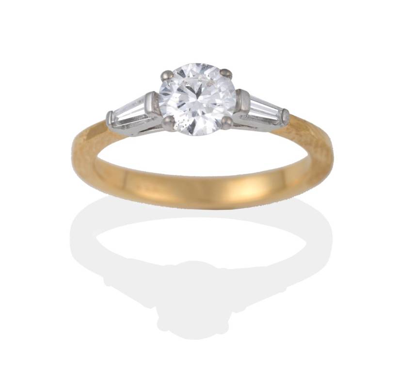 Lot 2014 - An 18 Carat Gold Diamond Solitaire Ring, a round brilliant cut diamond in a claw setting, to...