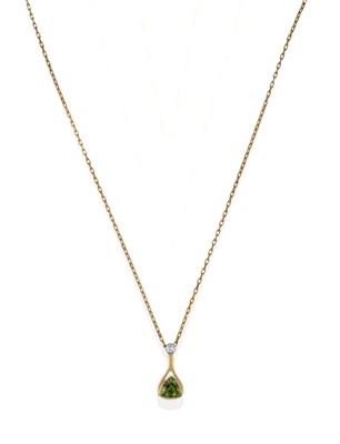 Lot 2015 - An 18 Carat Gold Diamond and Tourmaline Pendant on Chain, the drop pendant comprising a round...
